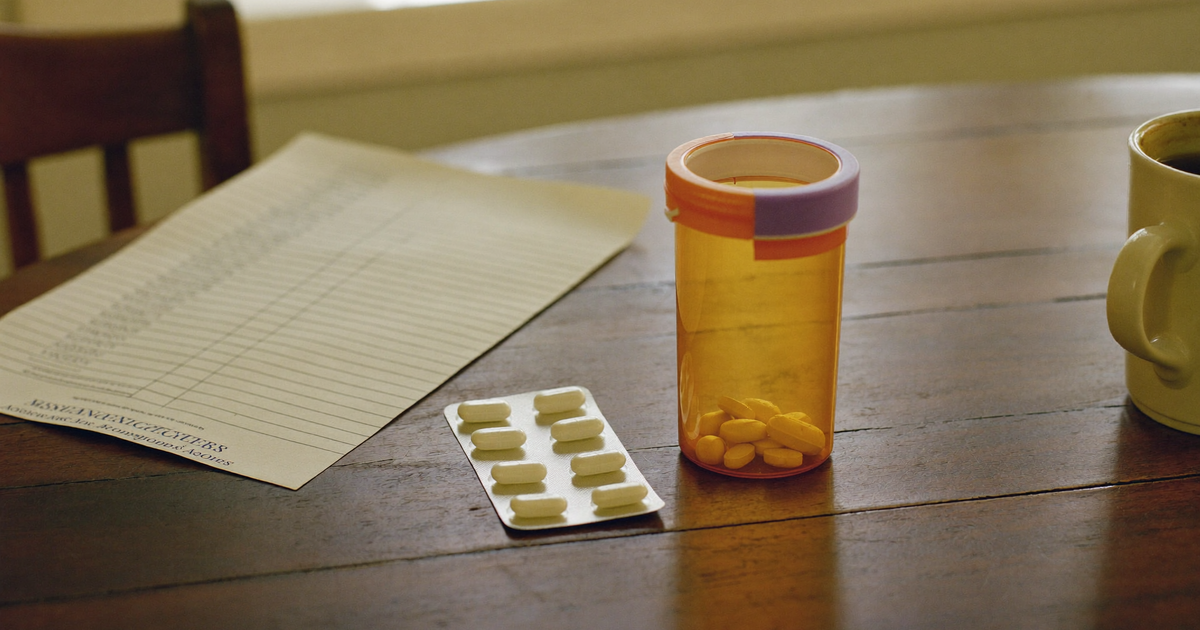 Rinvoq side effects explained with a bottle of upadacitinib extended-release tablets beside a lab results printout on a kitchen table